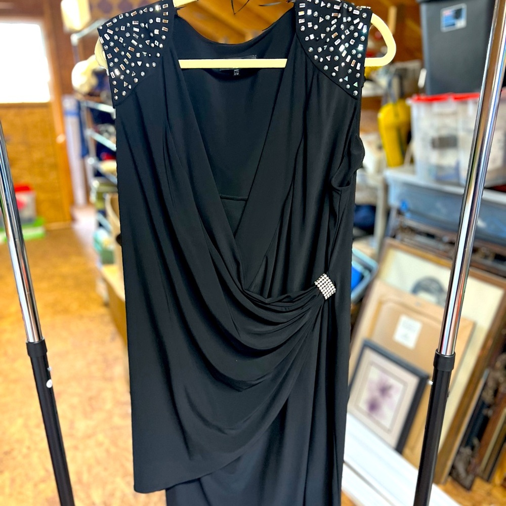 Black cocktail dress with jeweled shoulder embellishments and sash with pin.